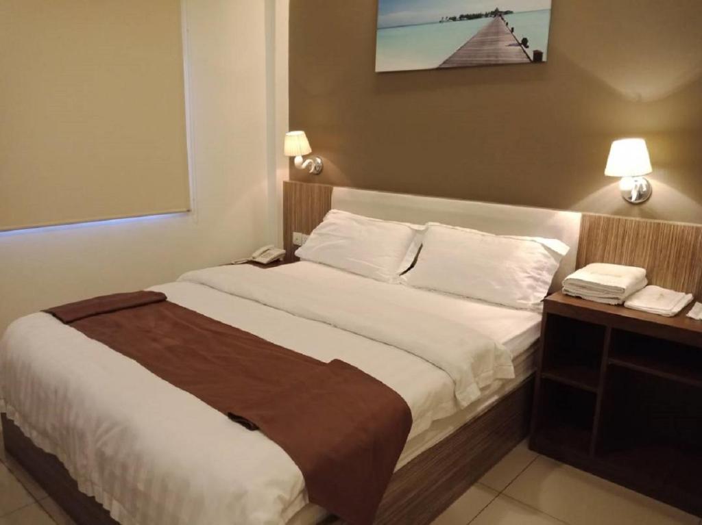 Postel nebo postele na pokoji v ubytování Oscar Suites Hotel