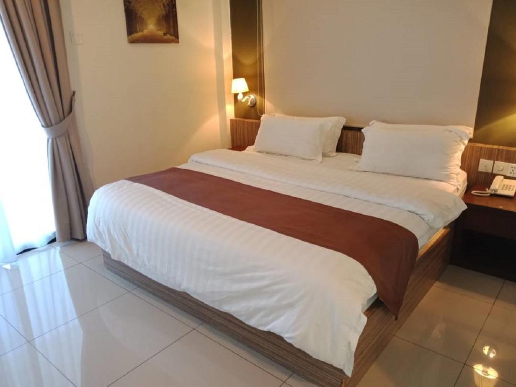 Postel nebo postele na pokoji v ubytování Oscar Suites Hotel
