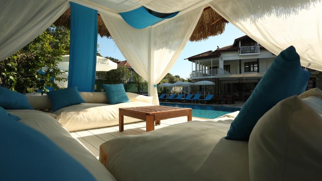 a patio with couches and a table and a pool at B&B Boutique Hotel in Dalyan