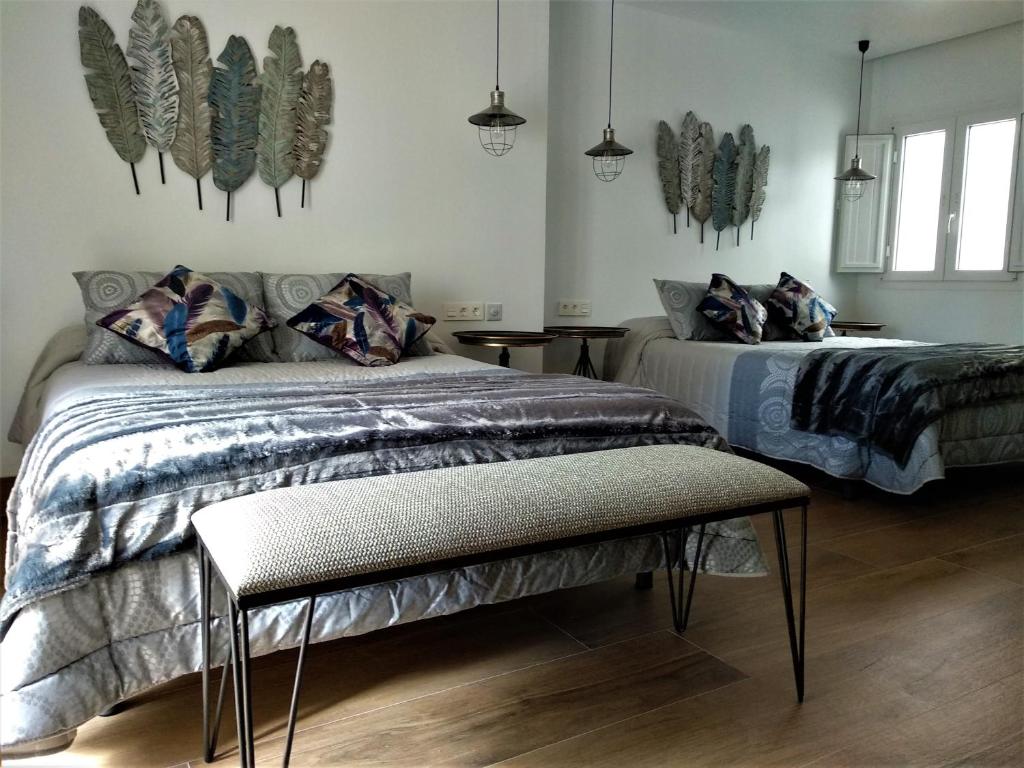 מיטה או מיטות בחדר ב-Hostal Enriqueta