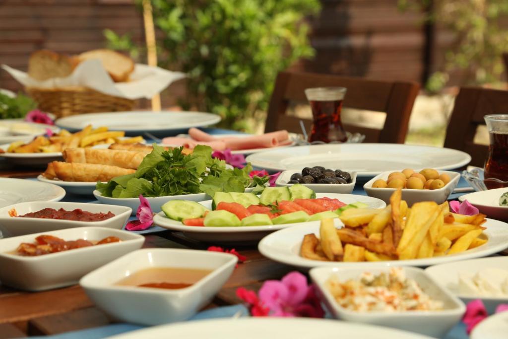 a table topped with plates of food and appetizers at B&B Boutique Hotel in Dalyan