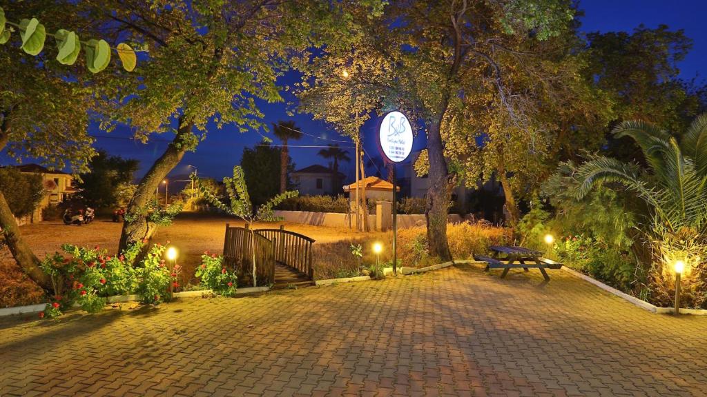 a park with a bench and a clock tower at night at B&B Boutique Hotel in Dalyan