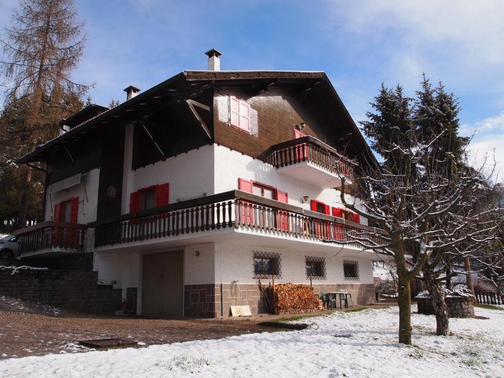 a large house with a balcony on top of it at Villa Wanda in Cavalese