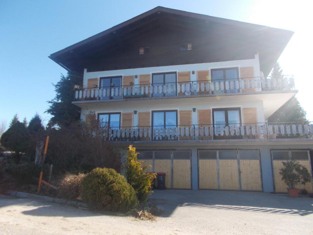 a large house with a balcony on top of it at Bauernhof Moadl in Weyregg