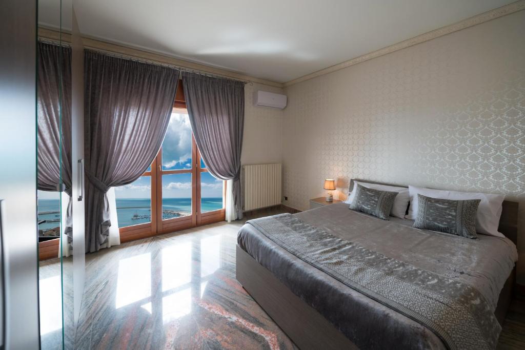 夏卡的住宿－Domus Aurea，一间卧室设有一张床,享有海景