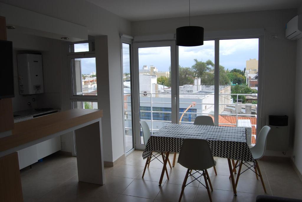 a kitchen and dining room with a table and chairs at Departamentos con cochera Peru 157 in Bahía Blanca