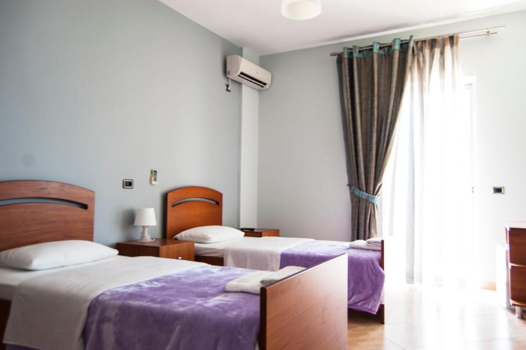 Postel nebo postele na pokoji v ubytování Dhima Hotel