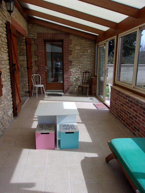 a patio with a white table and two boxes at Gîte à la campagne in Cressonsacq