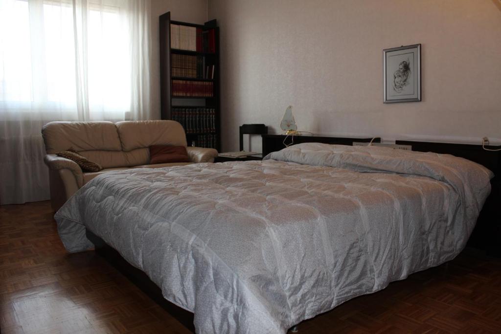 ein Schlafzimmer mit einem großen Bett und einem Sofa in der Unterkunft Da Federico in Triest