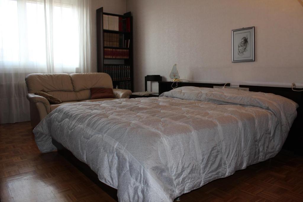 a bedroom with a large bed and a couch at Da Federico in Trieste