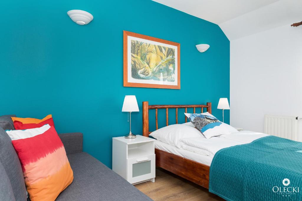 Posteľ alebo postele v izbe v ubytovaní OLECKI Holiday House