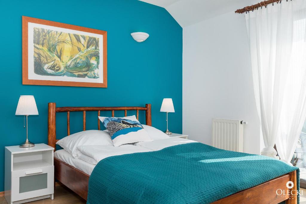 Posteľ alebo postele v izbe v ubytovaní OLECKI Holiday House