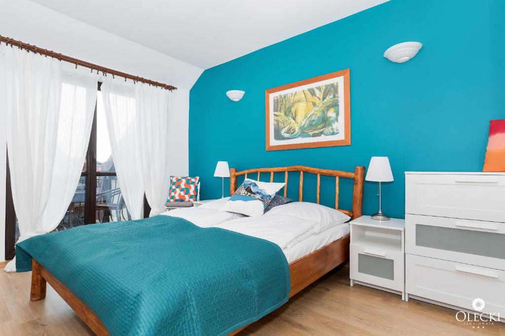 Posteľ alebo postele v izbe v ubytovaní OLECKI Holiday House