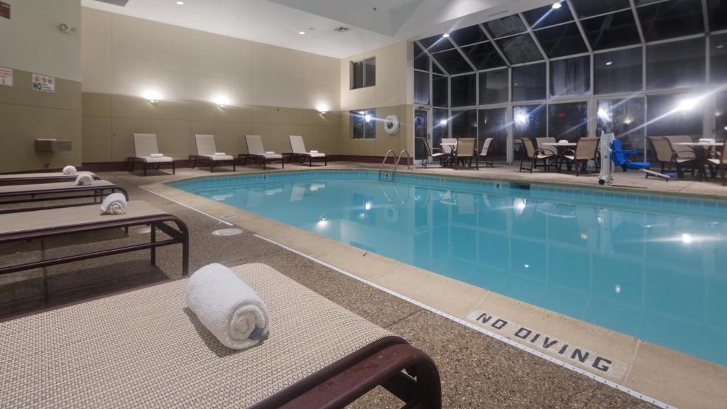 a pool with a no swimming sign in a hotel room at Chicago Club Inn & Suite in Oakbrook Terrace