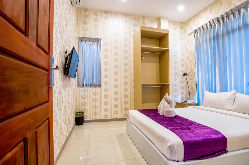 Postel nebo postele na pokoji v ubytování White Residence Hotel & Apartment