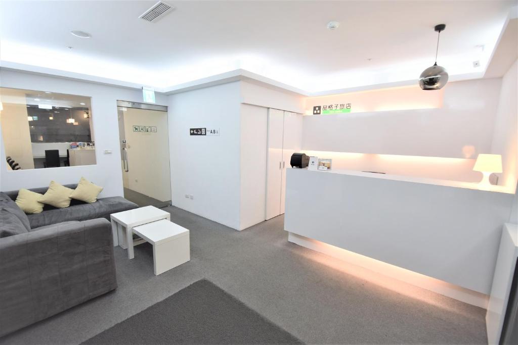 a living room with a couch and a table at Inn Cube - Ximen in Taipei