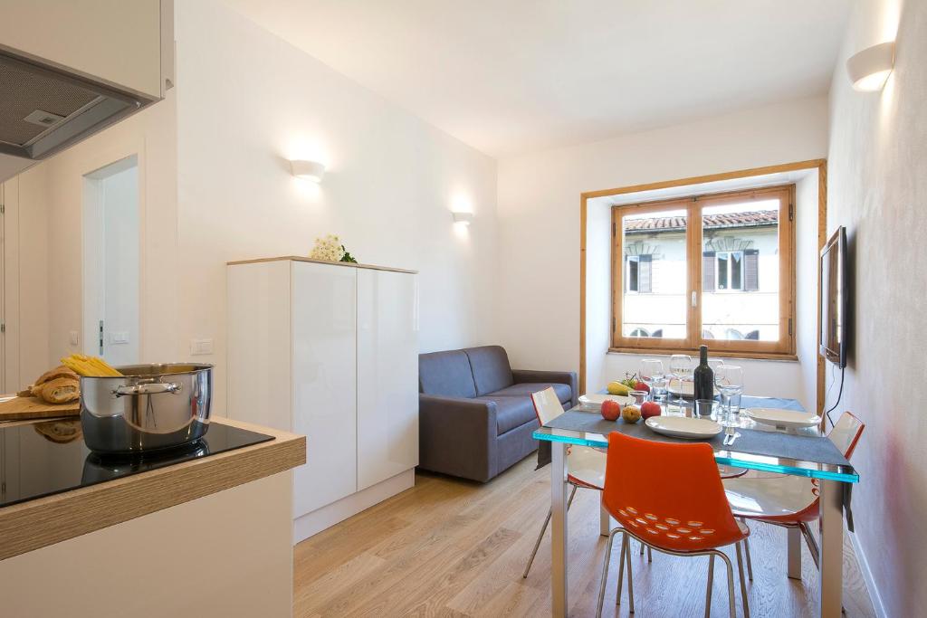 a kitchen and living room with a table and chairs at Alinari Apartment in Florence
