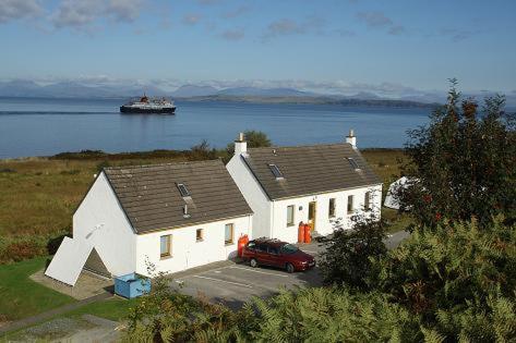a house with a red car parked in front of it at Shieling Holidays Mull in Craignure