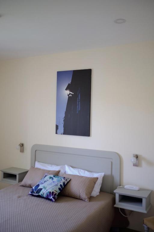 Postel nebo postele na pokoji v ubytování Hotel Os Poetas
