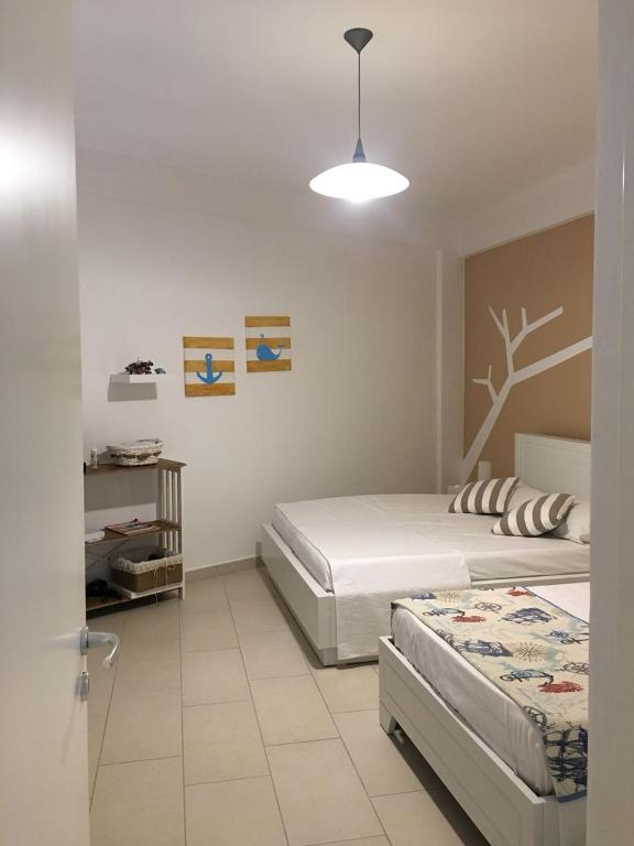 Llit o llits en una habitació de Aldi`s Guest House