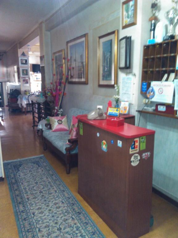 a living room with a table and a couch at Pensione Santachiara in Sanremo