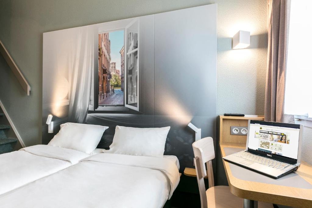Postel nebo postele na pokoji v ubytování B&B HOTEL Toulouse Cité de l'Espace Mouchotte