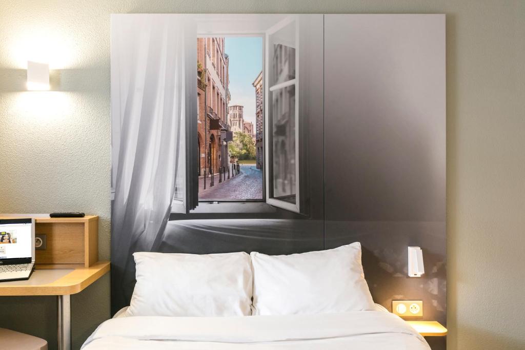Postel nebo postele na pokoji v ubytování B&B HOTEL Toulouse Cité de l'Espace Mouchotte
