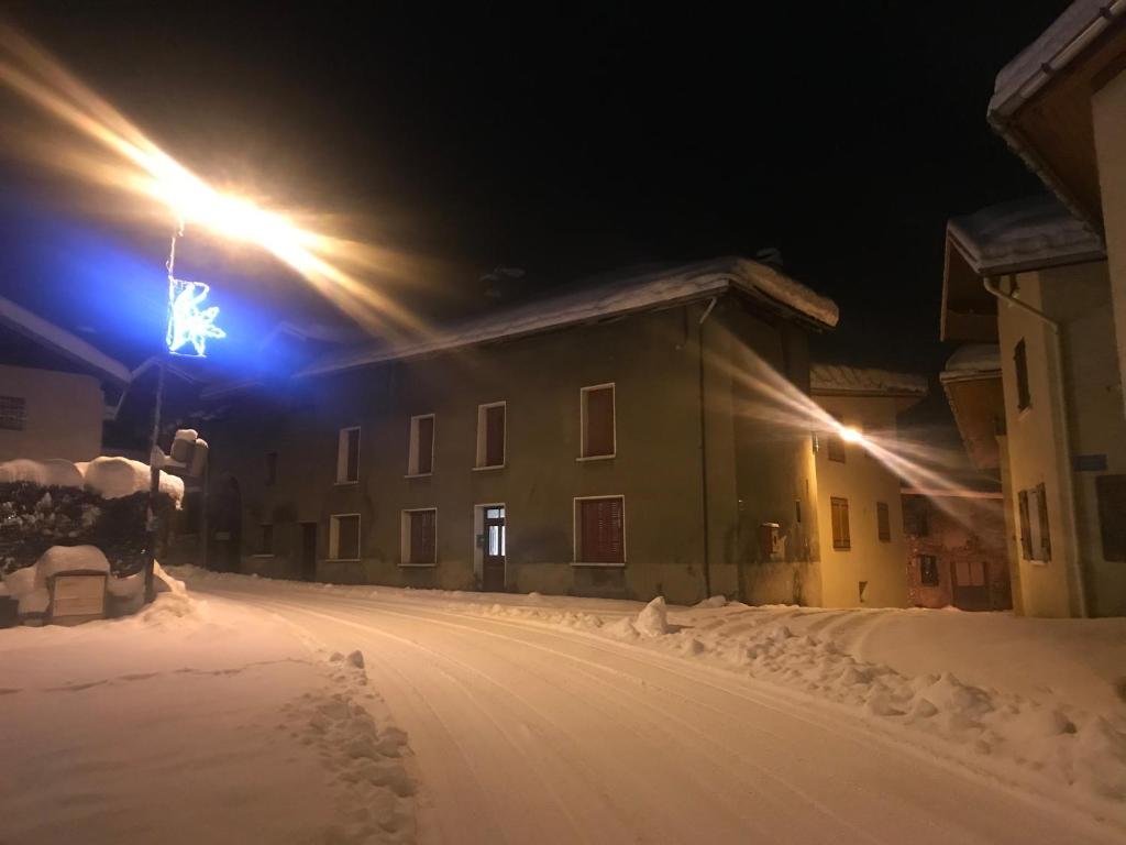 a street light in the snow at night at Chez Daisy in Longefoy