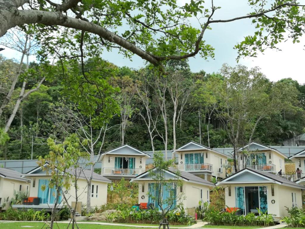 a row of houses with trees in the background at Krabi Home Resort in Tab Kaek Beach