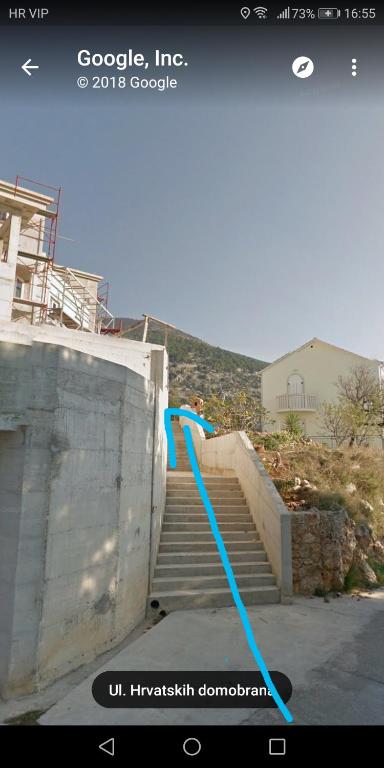 a blue hose is attached to a set of stairs at Rooms Anđelka in Bol