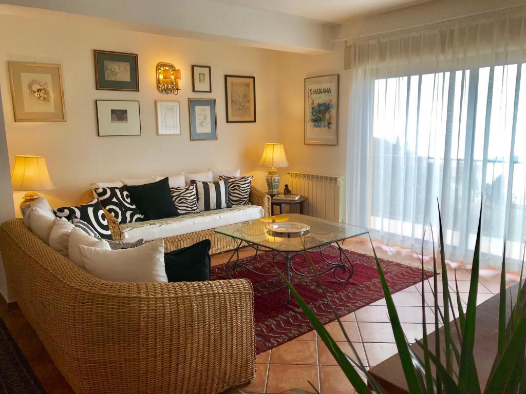 a living room with a couch and a table at BellaVista Apartments in Taormina