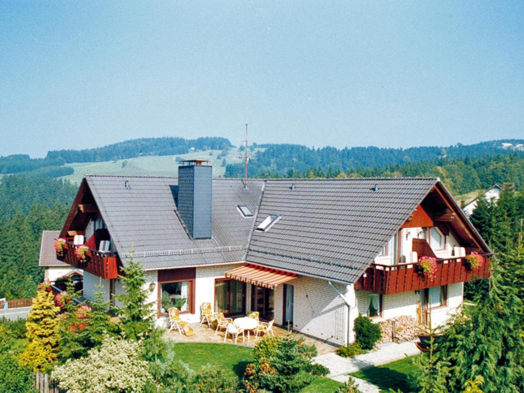 a house on top of a hill with trees at Landhaus Fischer in Sankt Andreasberg