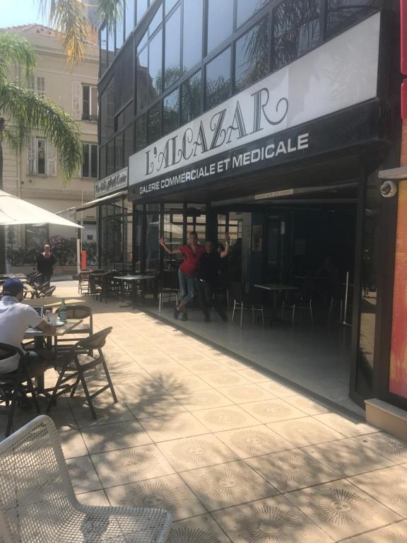 a restaurant with tables and chairs outside of a building at Monaco Studio "907" in Monte Carlo