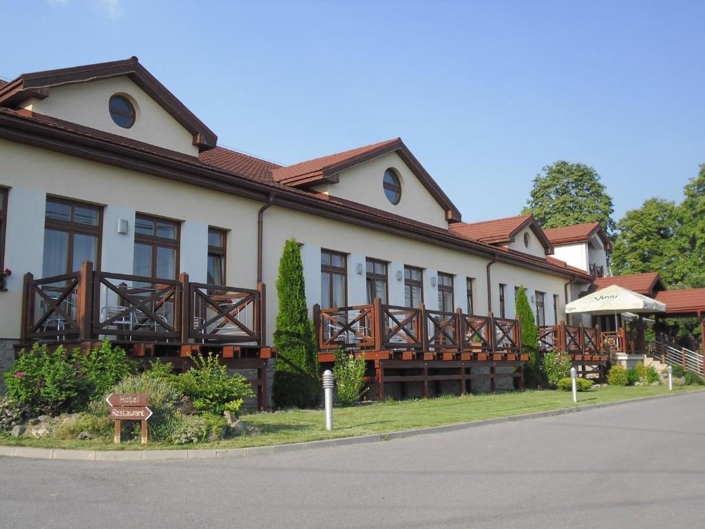 a building with wooden balconies on the side of it at RED DEER Hotel in Brezno