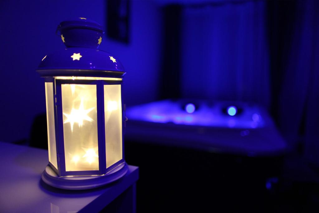 a blue lighted lantern sitting on a table in a dark room at Jac-Cosy in Fleurier