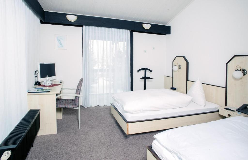 Postel nebo postele na pokoji v ubytování Hotel Abendroth