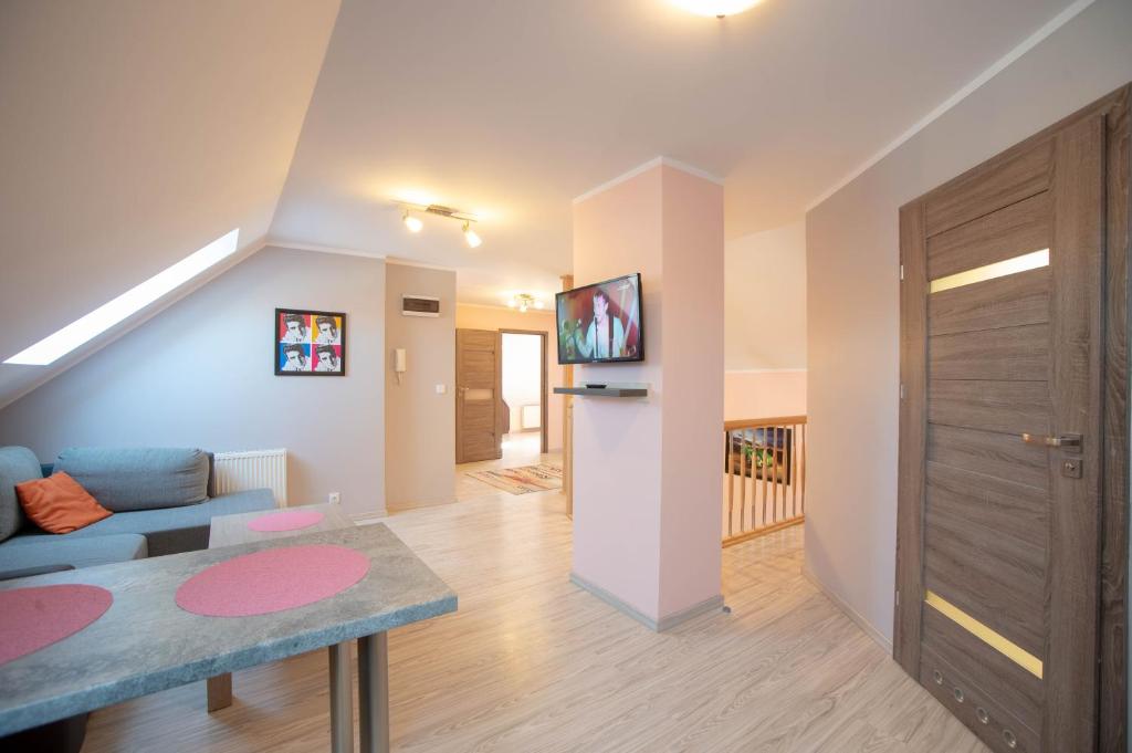 a living room with a couch and a table at Apartament Luna in Giżycko