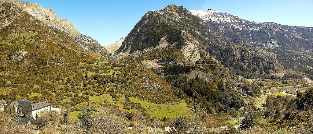 a mountain with a town in the middle of it at Hotel Santa Cristina Petit Spa in Canfranc-Estación