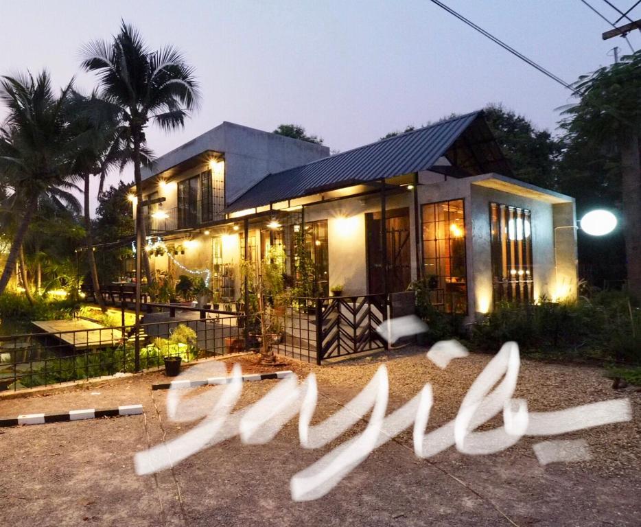 a house with a sign in front of it at Gajib Bed&Breakfast in Amphawa