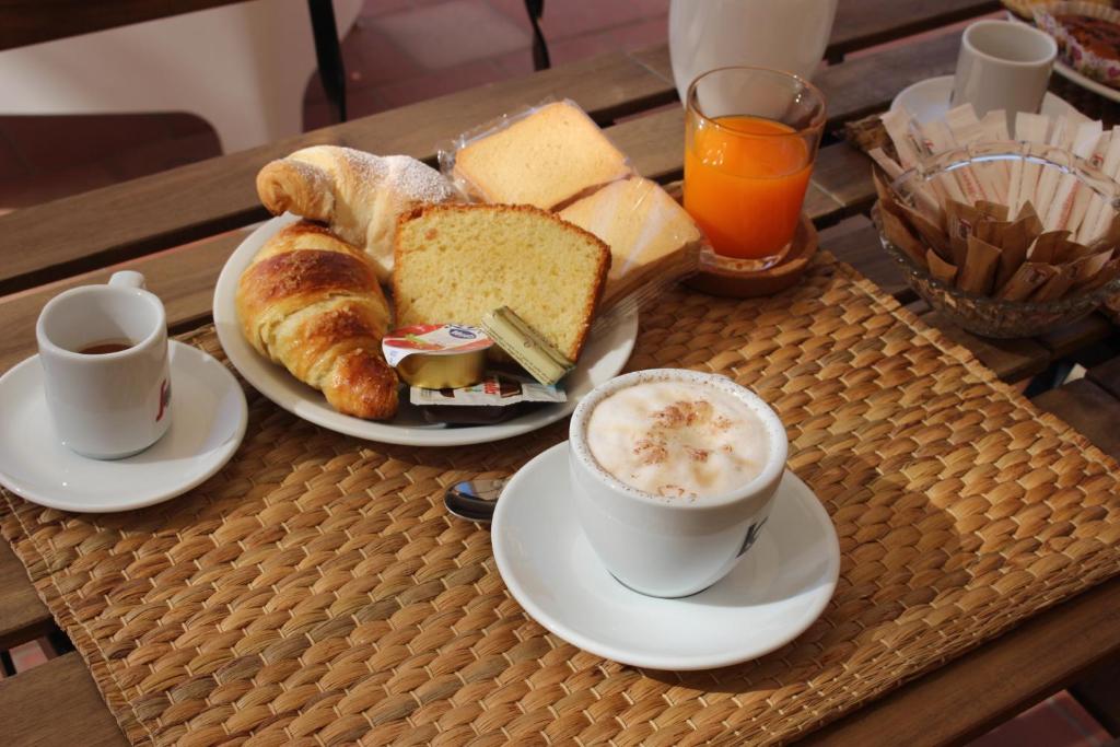 a tray with two plates of bread and a cup of coffee at B&B La Torre in Realmonte