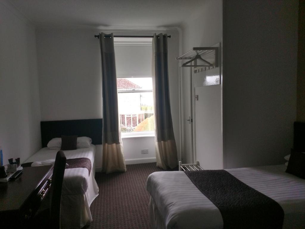 Postel nebo postele na pokoji v ubytování The Park Hotel