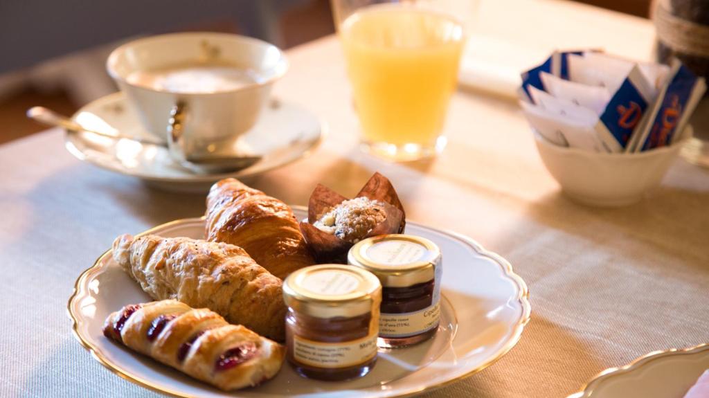 a plate of food with pastries on a table at Rinascimento Bed & Breakfast in Pisa