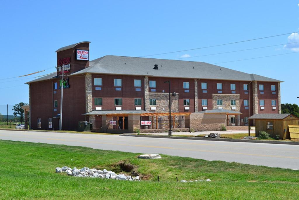 a large red brick building on the side of a road at Red River Inn and Suites in Thackerville