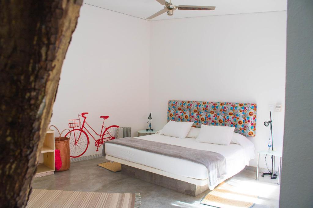 a bedroom with a bed and a red bike at Hotel Cosijo - San Jeronimo Tlacochahuaya in Oaxaca City