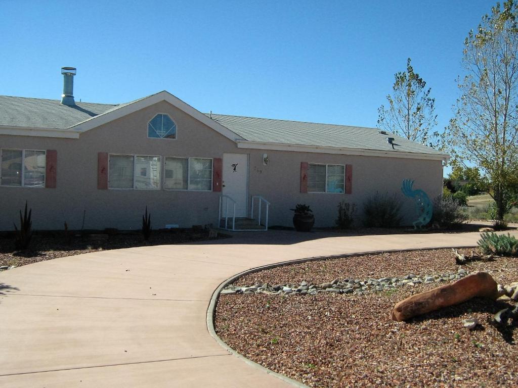 a house with a driveway in front of it at Kokopelli Kottage in Kanab