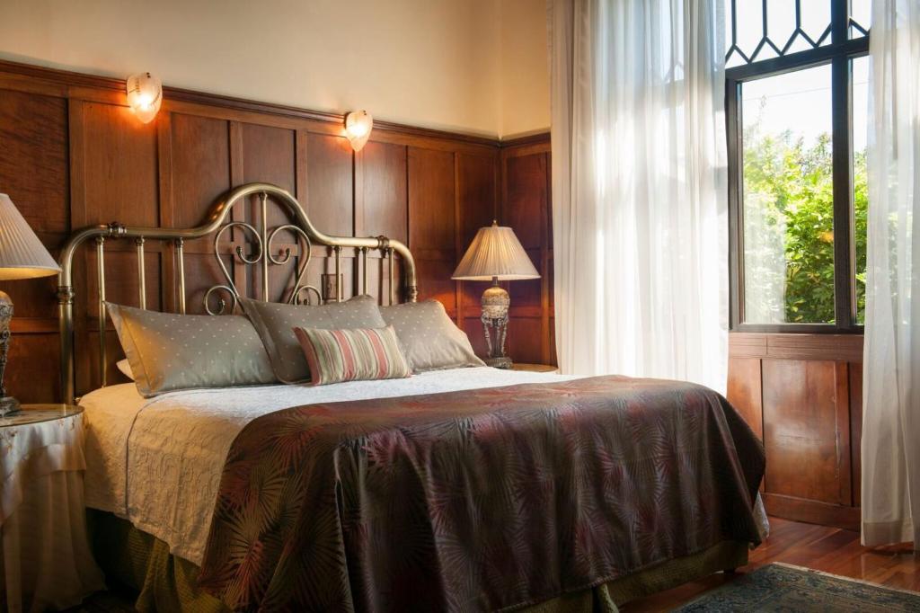 Postel nebo postele na pokoji v ubytování Grano de Oro Hotel