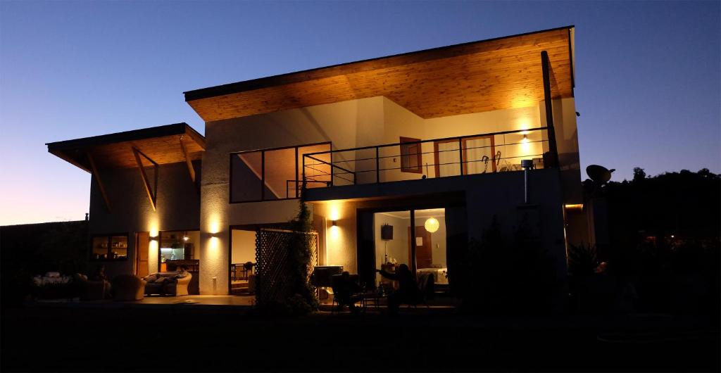 a large brick house with a man standing in front of it at Callihue Lodge in Santa Cruz