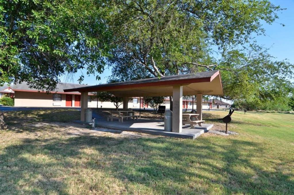 a pavilion with a picnic table in a park at SureStay Hotel by Best Western Zapata in Zapata