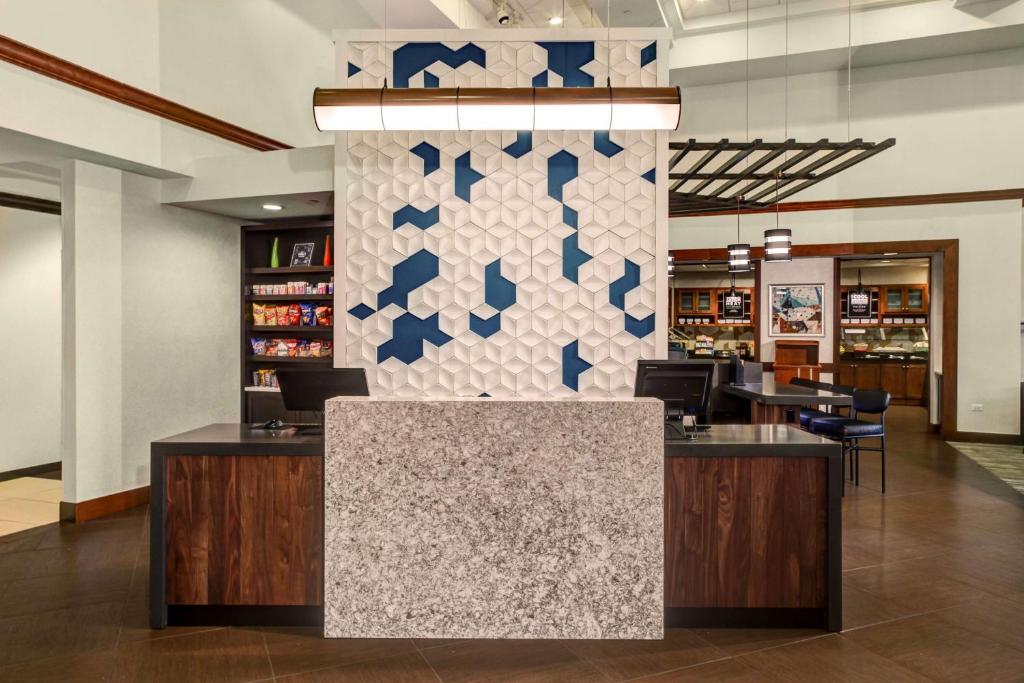 a lobby of a store with a counter and chairs at Hyatt Place Chicago/Itasca in Itasca