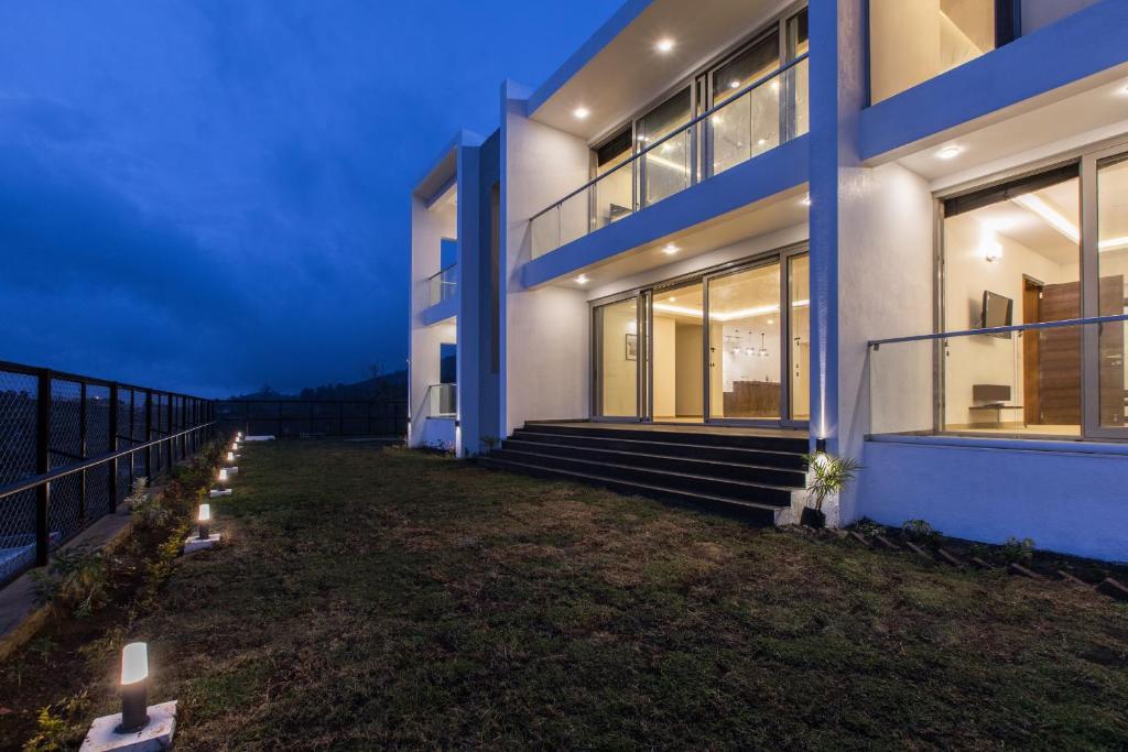 a house with lights on the side of it at Silver Mist in Kodaikānāl